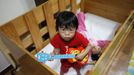 Lee Jin-ri (front), 5, and Choi Seol, 19, play at the Joosarang church in Seoul September 20, 2012. The two disabled children had been abandoned at a "baby box" at the church years earlier and have been raised since then at the church. Pastor Lee Jong-rak who runs the "baby box" where mothers can leave unwanted infants has seen a sharp increase in the number of newborns being left there because, the pastor says, of a new law aimed protecting the rights of children. South Korea is trying to shed a reputation of being a source of babies for adoption by people abroad. It is encouraging domestic adoption and tightening up the process of a child's transfer from birth mother to adoptive parents. Picture taken September 20, 2012. REUTERS/Kim Hong-Ji (SOUTH KOREA - Tags: SOCIETY) RELIGION) Published: Říj. 7, 2012, 6:53 dop.