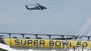 A U.S. military helicopter patrols before NFL Super Bowl 50 outside Levi's Stadium in Santa Clara, California,