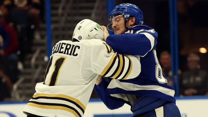 Mar 27, 2024; Tampa, Florida, USA; Boston Bruins center Trent Frederic (11) fights with Tampa Bay Lightning left wing Tanner Jeannot (84) during the first period at Amali