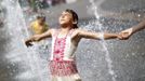 A girl plays with water fountains in a public square in Vienna, June 19, 2012. Temperatures are expected to rise up to 35 degrees Celsius (95 degrees Fahrenheit), Austria's national weather service agency ZAMG reported. REUTERS/Lisi Niesner (AUSTRIA - Tags: ENVIRONMENT SOCIETY) Published: Čer. 19, 2012, 3:24 odp.