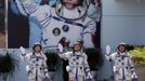 Chinese astronauts Jing Haipeng (C), Liu Wang (R) and Liu Yang, China's first female astronaut, wave in front of a picture of the first astronaut Yang Liwei during a departure ceremony at Jiuquan Satellite Launch Center, Gansu province, June 16, 2012. China will send its first woman into outer space this week, prompting a surge of national pride as the rising power takes its latest step towards putting a space station in orbit within the decade. Liu Yang, a 33-year-old fighter pilot, will join two other astronauts aboard the Shenzhou 9 spacecraft when it lifts off from a remote Gobi Desert launch site on Saturday evening. REUTERS/Jason Lee (CHINA - Tags: SCIENCE TECHNOLOGY) Published: Čer. 16, 2012, 8:48 dop.