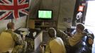 Britain's Prince Harry (R) relaxes with fellow Apache crew members as they play a computer soccer game at Camp Bastion, southern Afghanistan in this photograph taken November 1, 2012, and released January 21, 2013. The Prince, who is serving as a pilot/gunner with 662 Squadron Army Air Corps, is on a posting to Afghanistan that runs from September 2012 to January 2013. Photograph taken November 1, 2012. REUTERS/John Stillwell/Pool (AFGHANISTAN - Tags: MILITARY POLITICS SOCIETY MEDIA ROYALS CONFLICT) Published: Led. 21, 2013, 8:55 odp.