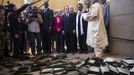 France's President Francois Hollande (5thR) flanked by Mali's interim president Dioncounda Traore (3dR), French Foreign Affairs minister Laurent Fabius (4thR) and UNESCO general director Irina Bokova (C) visit the archives where documents were burnt in Timbuktu during his one-day visit in Mali, February 2, 2013. Islamists had torched the building housing priceless ancient manuscripts as they fled the town. French President Hollande flew to Mali on Saturday to support French troops fighting Islamist rebels in the Sahel nation and he visited the famed ancient city of Timbuktu that was recaptured from al Qaeda-allied fighters six days ago. REUTERS/Fred Dufour/Pool (MALI - Tags: POLITICS CONFLICT CIVIL UNREST) Published: Úno. 2, 2013, 12:55 odp.