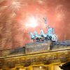 Fireworks explode next to the Quadriga sculpture atop the Brandenburg gate during New Year celebrations in Berlin