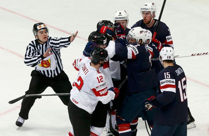 Players of the U.S. and Switzerland fight during the first period of their men's ice hockey World Championship group B game at Minsk Arena in Minsk May 10, 2014. REUTERS/