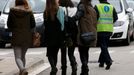 An assistant (R) escorts people believed to be family members of those killed in Germanwings plane crash as they arrive at Barcelona's El Prat airport March 24, 2015.