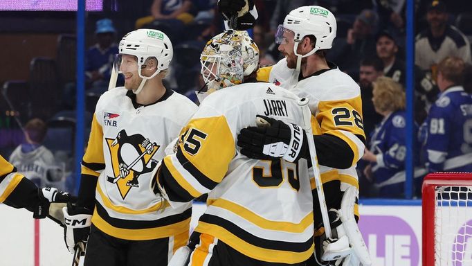 Nov 30, 2023; Tampa, Florida, USA; Pittsburgh Penguins goaltender Tristan Jarry (35), defenseman Marcus Pettersson (28) and teammates celebrate after they beat the Tampa