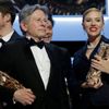 Roman Polanski and Scarlett Johansson pose with their trophies during the 39th Cesar Awards ceremony in Paris