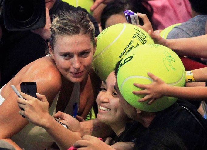 Maria Sharapova of the Manila Mavericks team poses for photos with fans after beating Kristina Mladenovic of the UAE Royals team in their women's singles tennis match at