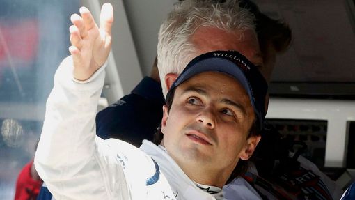 Williams Formula One driver Felipe Massa of Brazil speaks to his crew on the pit wall during the first practice session of the Australian F1 Grand Prix at the Albert Park