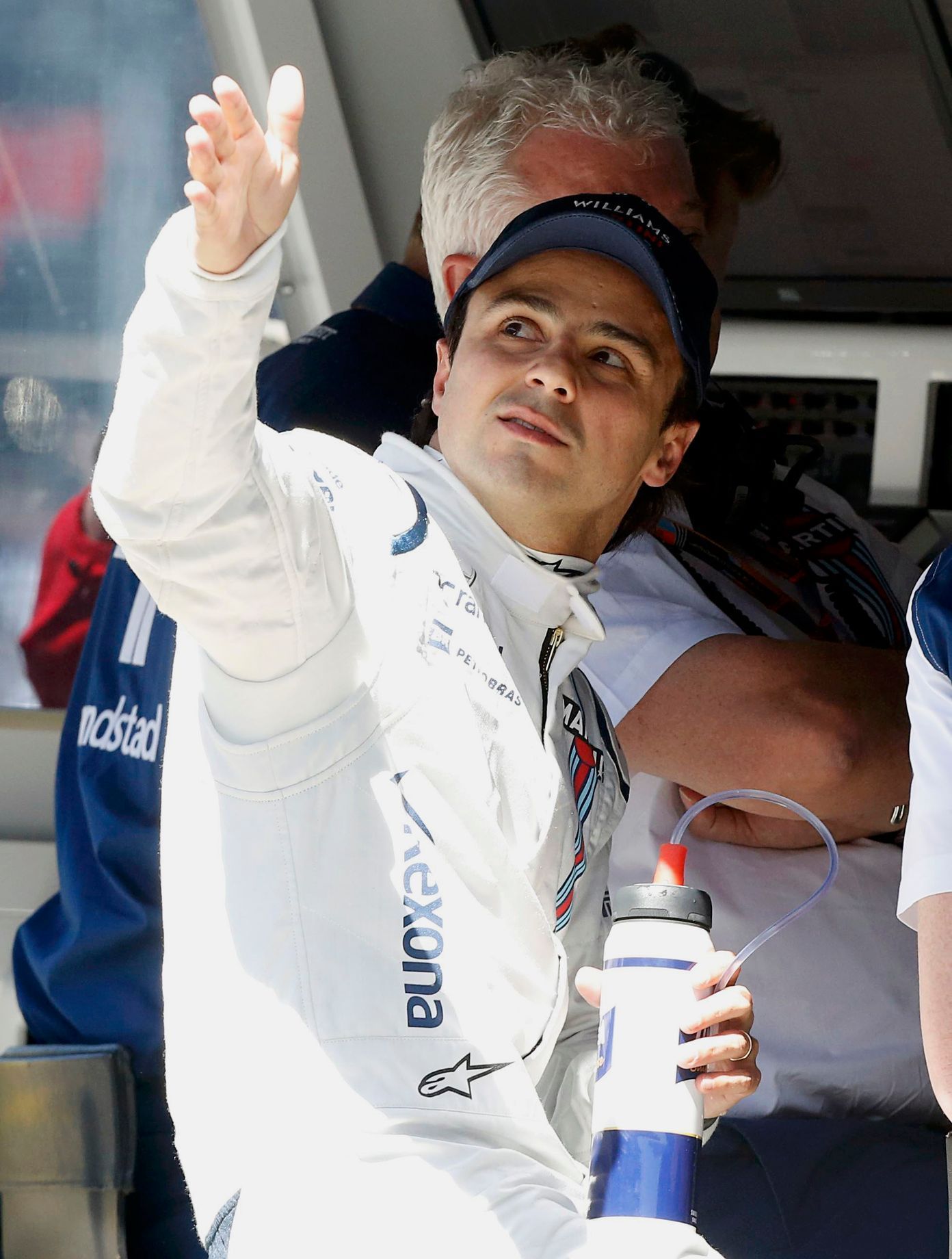 Williams Formula One driver Felipe Massa of Brazil speaks to his crew on the pit wall during the first practice session of the Australian F1 Grand Prix at the Albert Park circuit in Melbourne