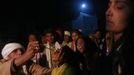 A Hindu priest offers holy water to a devotee who is believed to be possessed by evil spirits as another shouts in a state of trance at Guru Deoji Maharaj temple during a ghost fair at Malajpur village in Betul district in the central Indian state of Madhya Pradesh January 27, 2013. People from across India come to this fair to be exorcised of �evil spirits�. They are usually brought by relatives and they are most often women. The exorcism involves running around the temple courtyard to make the 'ghost' weak then being beaten by a priest with a broom. Picture taken January 27, 2013. REUTERS/Danish Siddiqui (INDIA - Tags: SOCIETY RELIGION) ATTENTION EDITORS: PICTURE 17 OF 24 FOR PACKAGE 'INDIAN GHOSTBUSTERS' SEARCH 'INDIA GHOST' FOR ALL IMAGES Published: Úno. 5, 2013, 5:10 dop.