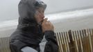 Local resident Roger Vanwart smokes a cigarette as he watches waves batter the beach at Dewey Beach, Delaware, October 29, 2012. Hurricane Sandy, the monster storm bearing down on the U.S. East Coast, strengthened on Monday after hundreds of thousands moved to higher ground, public transport shut down and the U.S. stock market suffered its first weather-related closure in 27 years. REUTERS/Jonathan Ernst (UNITED STATES - Tags: ENVIRONMENT) Published: Říj. 29, 2012, 1:57 odp.