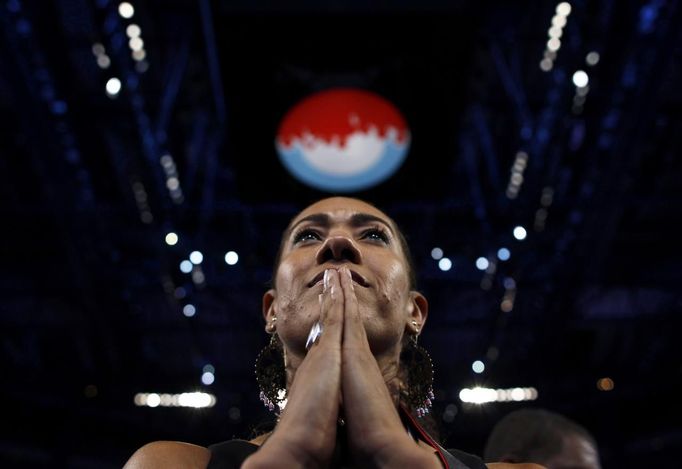 A delegate watches as U.S. first lady Michelle Obama addresses the first session of the Democratic National Convention in Charlotte, North Carolina, September 4, 2012. REUTERS/Jim Young (UNITED STATES - Tags: POLITICS ELECTIONS) Published: Zář. 5, 2012, 4 dop.