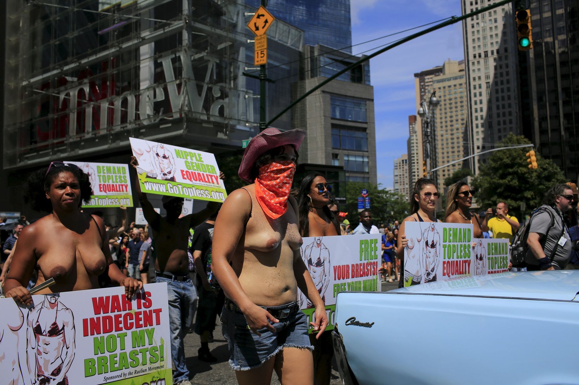 People take part in a topless march in New York