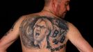 File photo of soccer fan Martin Hueschen showing his tattoo of Germany's soccer trophy and Borussia Dortmund soccer club coach Juergen Klopp in Dortmund