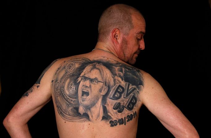 File photo of soccer fan Martin Hueschen showing his tattoo of Germany's soccer trophy and Borussia Dortmund soccer club coach Juergen Klopp in Dortmund