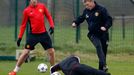 Manchester United's manager Moyes is challenged by Rooney during a training session at the club's Carrington training complex in Manchester