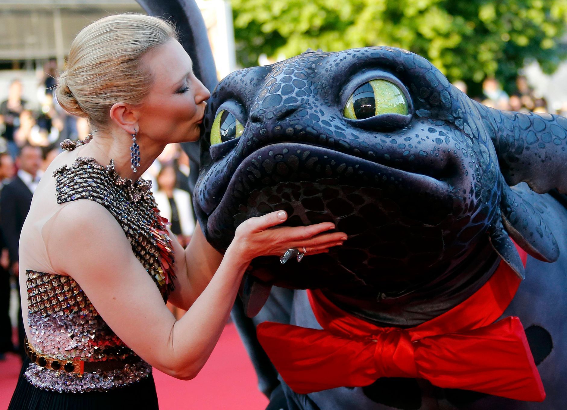 Actress Cate Blanchett poses on the red carpet with a figure of Toothless the Dragon character as she arrives for the screening of the film &quot;How to Train Your Dragon 2&quot; out of competition at