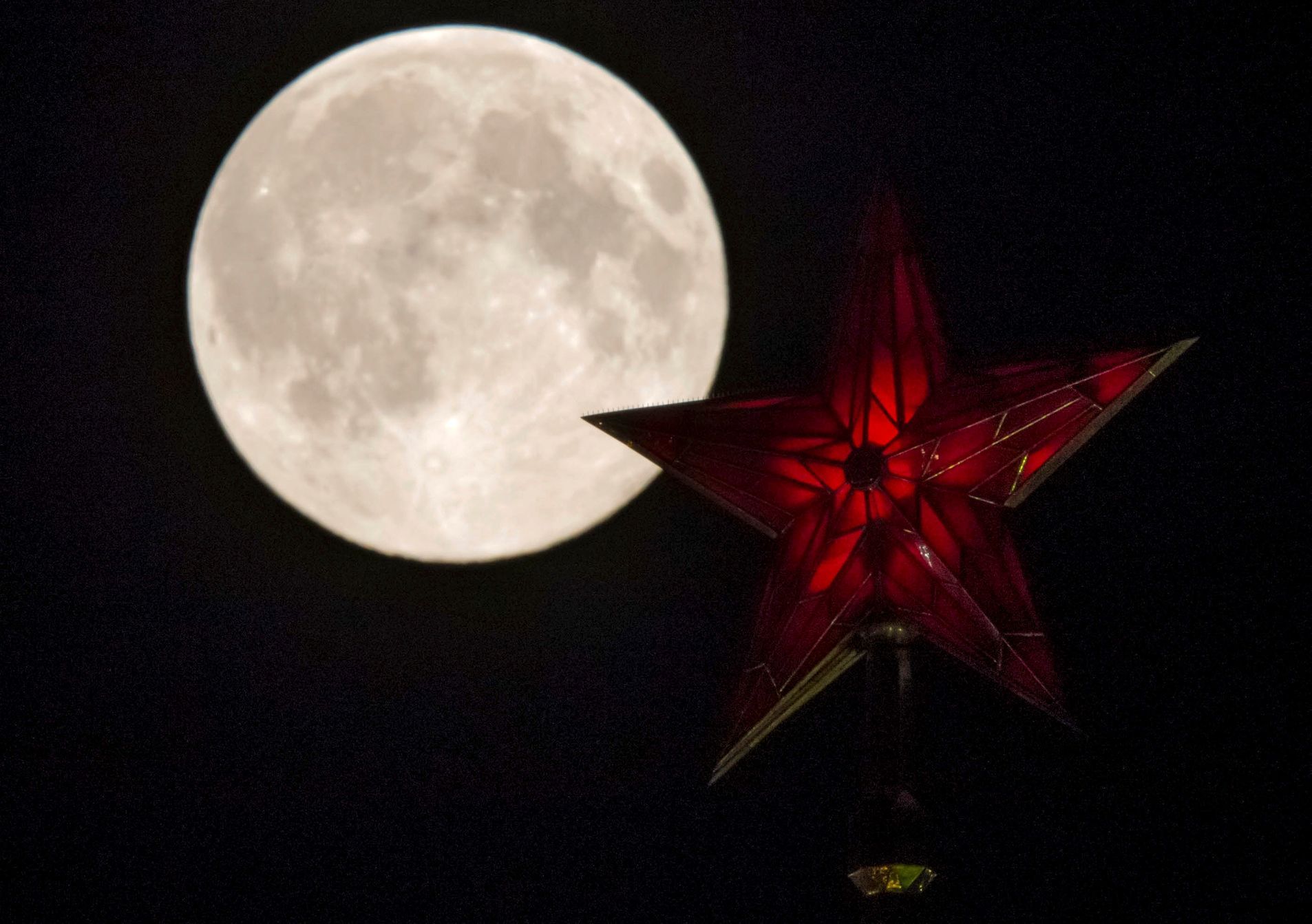 The supermoon rises over the stars of Moscow's Kremlin towers in Moscow