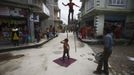 Gchan Choudhary, 17, (R) plays a drum as his siblings Drumpal, 11, and Shivani, 7, perform on a street in Kathmandu August 15, 2012. The siblings, who came to Kathmandu from India 5 years ago, earn their living by performing tricks on the streets of Kathmandu. According to Drumpal they earn around $10 a day by performing tricks, which is not enough to feed their 10-member family living together in a small hut without a proper toilet or any basic needs. REUTERS/Navesh Chitrakar (NEPAL - Tags: SOCIETY IMMIGRATION POVERTY) Published: Srp. 15, 2012, 4:34 odp.