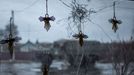 Angel figurines are seen on a window of a local grocery store broken by shrapnel while a Ukrainian Army truck moves past in a village near a frontline, amid Russia's atta