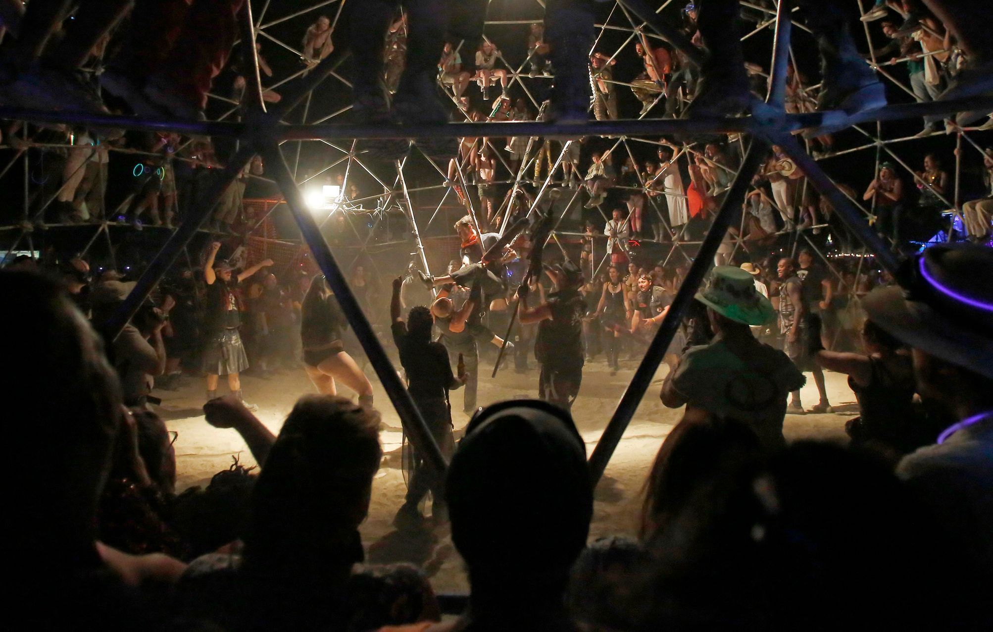 A crowd watches as two fighters battle in the Thunderdome during the Burning Man 2014 &quot;Caravansary&quot; arts and music festival in the Black Rock Desert of Nevada
