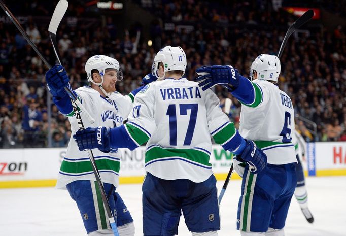 Mar 21, 2015; Los Angeles, CA, USA; Vancouver Canucks right wing Radim Vrbata (17) celebrates with left wing Yannick Weber (right) and left wing Daniel Sedin (left) again