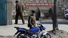 A soldier stands by a motorbike along the banks of Yalu River near the North Korean town of Sinuiju, opposite the Chinese border city of Dandong, March 29, 2013. China called for an easing of tensions on Friday as North Korea put its missile units on standby to attack U.S. military bases in South Korea and the Pacific after the United States flew two nuclear-capable stealth bombers over the Korean peninsula. REUTERS/Jacky Chen