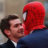 Actor Andrew Garfield messes around with a friend wearing a Spider Man mask at the world premiere of The Amazing Spiderman 2 in central London