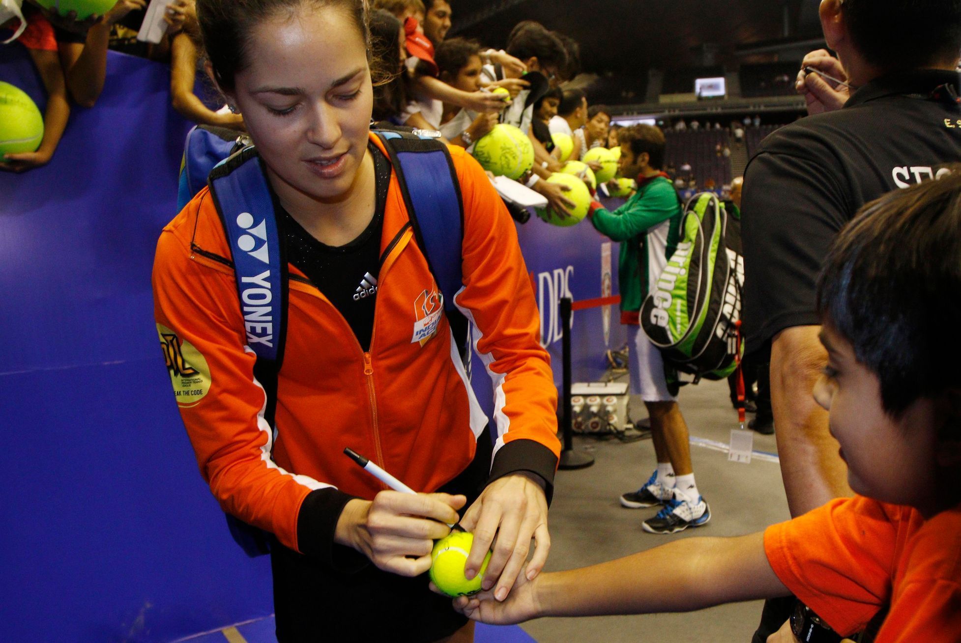 Team Micromax Indian Aces'  Ana Ivanovic of Serbia signs autographs after matches against UAE Royals at the International Premier Tennis League (IPTL) in Singapore