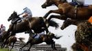 Horses jump a fence during hurdle race at the Cheltenham Festival horse racing meet in Gloucestershire, western England March 14, 2012.