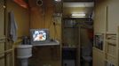 A movie is shown on a television in a common area between wooden boxes where people live in, Hong Kong October 9, 2012. In Hong Kong's middle-class residential area, short distance from its shopping and financial districts, 24 people live in these wooden boxes, or "coffin homes", packed in a single apartment of little over 50 square meters. Its residents pay 1450 Hong Kong dollars ($180) for their living space built of wooden panels of 2 meters by 70 cm. To maximize income from the rent in central Hong Kong landlords build "coffin homes", nicknamed due to their resemblance to real coffins. Space has always been at a premium in Hong Kong where developers plant high-rises on every available inch. REUTERS/Damir Sagolj (CHINA - Tags: SOCIETY REAL ESTATE BUSINESS) Published: Říj. 9, 2012, 1:51 odp.