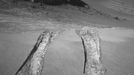 NASA's Mars Exploration Rover Opportunity climbed out of "Victoria Crater" following the tracks it had made when it descended into the 800-meter-diameter (half-mile-diameter) bowl nearly a year earlier. The rover's navigation camera captured this view back into the crater just after finishing a 6.8-meter (22-foot) drive that brought Opportunity out onto level ground during the mission's 1,634th Martian day, or sol (Aug. 28, 2008). The rover laid down the first tracks at this entry and exit point during its 1,291st sol (Sept. 11, 2007), after about a year of exploring around the outside of Victoria Crater for the best access route to the interior. On that sol, Opportunity drove a short distance into the crater and then backed out to check that the footing was good enough to trust this point as an exit route when the work in the crater was finished. Two sols later, Opportunity drove in again for its extended investigation of the rock layers exposed inside the crater. While inside, the rover spent several months using the contact instruments on its robotic arm to analyze the composition of the rock layers it could drive across on the surface of the upper slope. Then Opportunity drove close to the base of the "Cape Verde" promontory that forms part of the crater rim and appears in the upper center of this image. From that perspective, the rover used its panoramic camera to examine details of layering in the 6-meter-tall (20-foot-tall) cliff. For scale, the distance between the parallel tracks left by the rover's wheels is about 1 meter (39 inches) from the middle of one track to the middle of the other. After getting past the top of the inner slope of the crater, the Sol 1634 drive also got through a sand ripple where the tracks appear deepest. Image Credit: NASA/JPL-Caltech