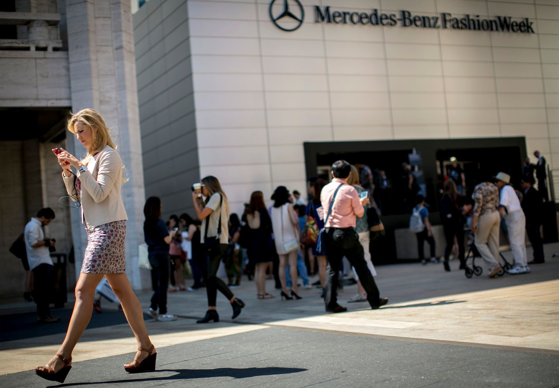 People gather outside the tents at the Spring/Summer 2015 New York Fashion Week at Lincoln Center