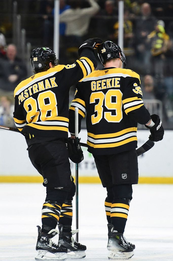 Feb 4, 2025; Boston, Massachusetts, USA; Boston Bruins right wing David Pastrnak (88) congratulates center Morgan Geekie (39) after scoring an empty net goal during the t