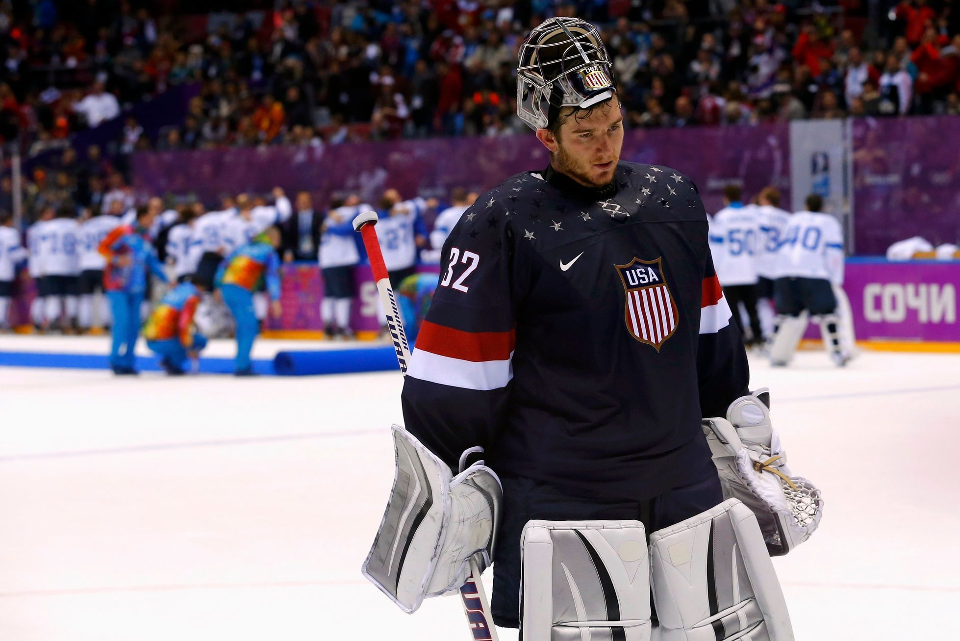 Team USA's goalie Quick leaves the ice after being defeated by Finland during the third period of their men's ice hockey bronze medal game at the Sochi 2014 Winter Olympic Games
