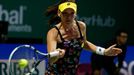 Agnieszka Radwanska of Poland hits a return to Petra Kvitova of the Czech Republic during their WTA Finals singles tennis match at the Singapore Indoor Stadium October 22