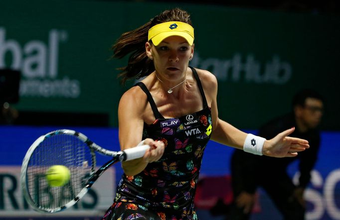 Agnieszka Radwanska of Poland hits a return to Petra Kvitova of the Czech Republic during their WTA Finals singles tennis match at the Singapore Indoor Stadium October 22