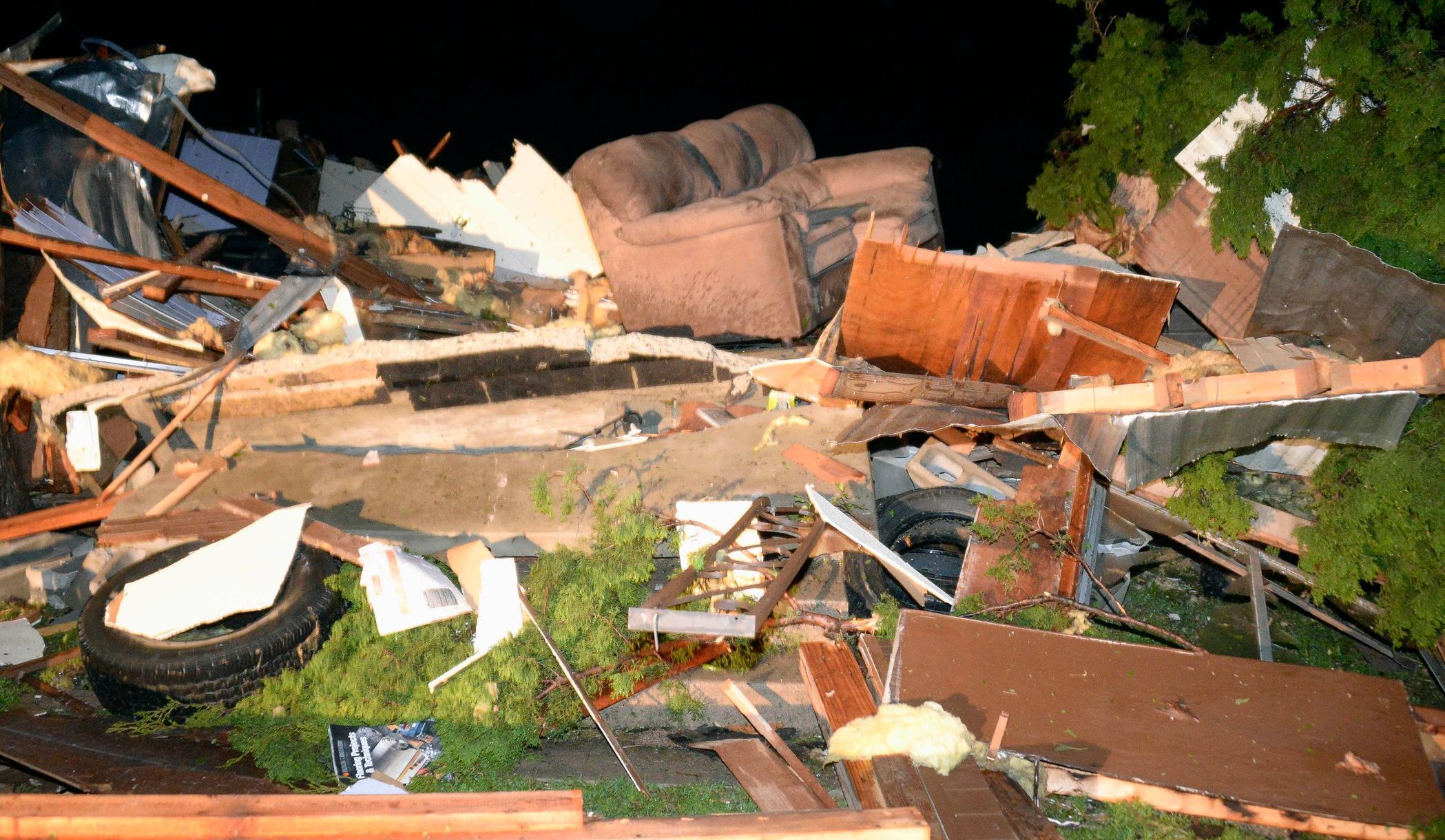 Debris from a damaged home is seen after a tornado hit the town of Mayflower, Arkansas