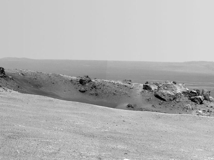 Arrival at 'Spirit Point' by Mars Rover Opportunity NASA's Mars Exploration Rover Opportunity arrived at the rim of Endeavour crater on Aug. 9, 2011, after a trek of more than 13 miles (21 kilometers) lasting nearly three years since departing the rover's previous major destination, Victoria crater, in August 2008. After arrival, Opportunity used its panoramic camera (Pancam) to record the images combined into this mosaic view. The view scene shows the "Spirit Point" area of the rim, including a small crater, "Odyssey" on the rim, and the interior of Endeavour beyond. Image Credit: NASA/JPL-Caltech/Cornell/ASU