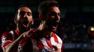 Atletico Madrid's Adrian Lopez (R) celebrates with team mate Arda Turan (L) after scoring the first goal for the team during their Champions League semi-final second leg