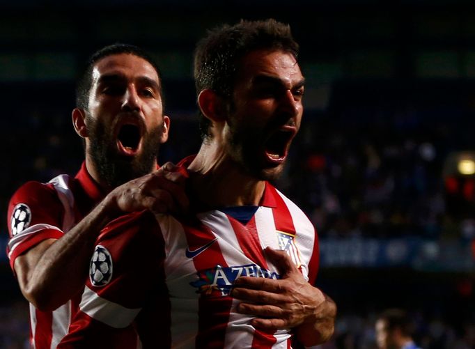 Atletico Madrid's Adrian Lopez (R) celebrates with team mate Arda Turan (L) after scoring the first goal for the team during their Champions League semi-final second leg