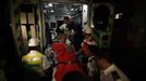 A survivor is taken onto shore by rescuers after a collision involving two vessels in Hong Kong October 2, 2012. A major rescue is underway in the waters near Yung Shue Wan on Hong Kong's Lamma island following a collision involving two vessels in the evening, government radio reported on Monday. Police say there were about 100 people onboard both vessels, with many of them in the water. The government says 101 people have been rescued so far with at least 25 hospitalised. REUTERS/Tyrone Siu (CHINA - Tags: DISASTER TRANSPORT) Published: Říj. 1, 2012, 7:26 odp.