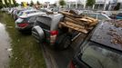 A wooden pallet and burning wood got stuck between two cars after the floods of the nearby Danube river subsided at a car dealership in Fischerdorf, a suburb of the eastern Bavarian city of Deggendorf June 10, 2013. Tens of thousands of people have been forced to leave their homes and there have been at least a dozen deaths as a result of floods that have hit Germany, Austria, Slovakia, Poland and the Czech Republic over the past week. REUTERS/Wolfgang Rattay (GERMANY - Tags: DISASTER TRANSPORT)