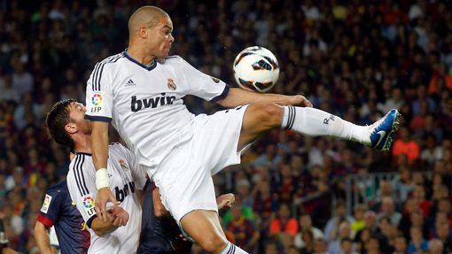 Fotbalista Realu Madrid Pepé (vpravo) skáče pro míč nad spoluhráče Xabi Alonsa v utkání Primera División proti Barceloně.