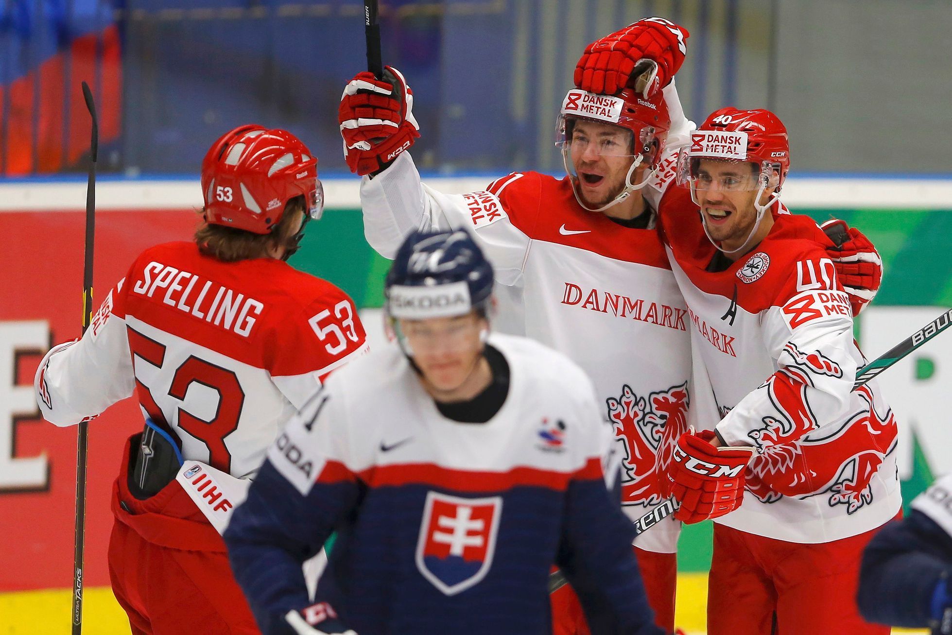Denmark's Bjorkstrand celebrates his goal against Slovakia with his teammates Jensen and Spelling during their Ice Hockey World Championship game at the CEZ arena in Ostrava