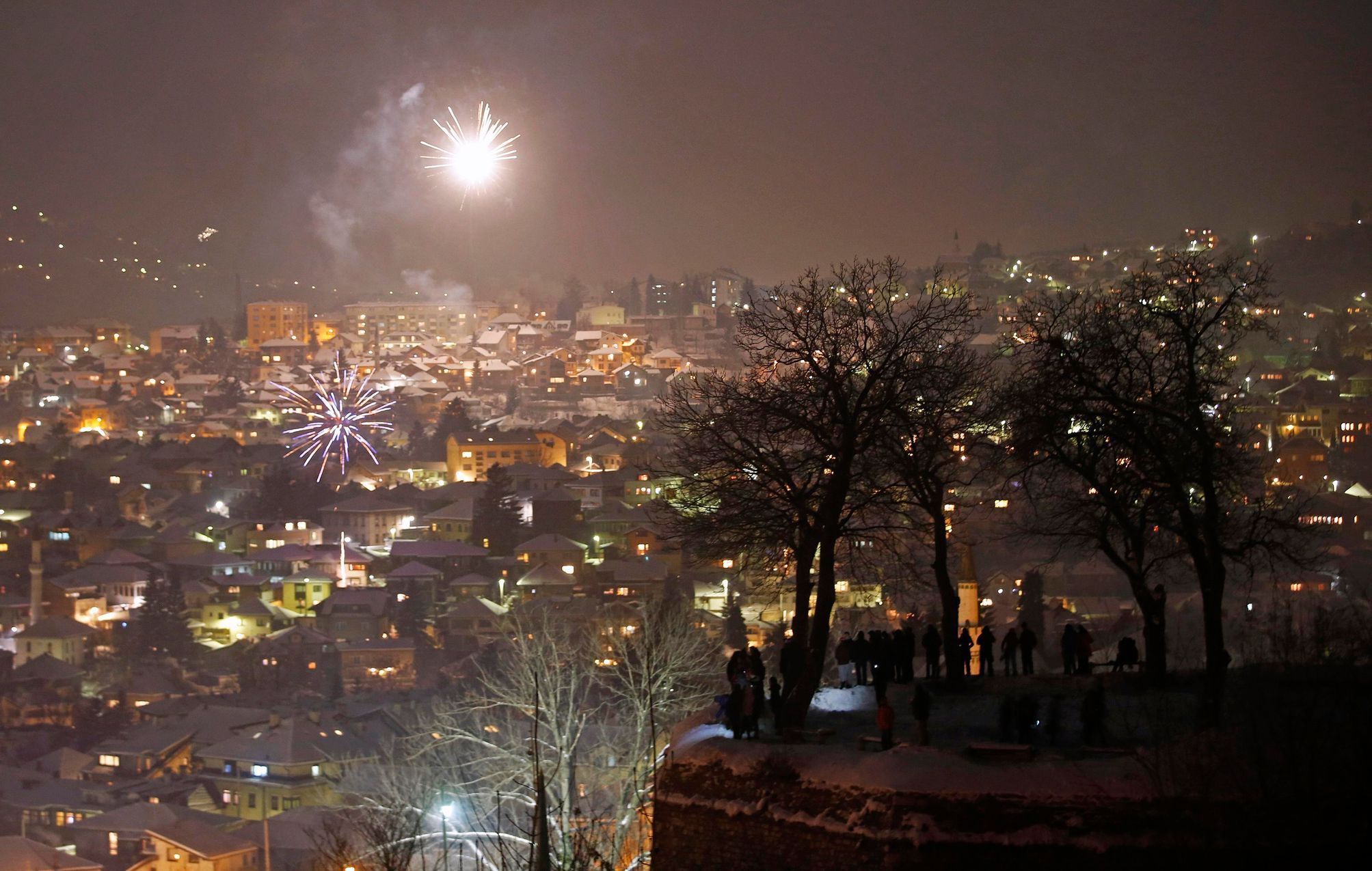 People watch fireworks during New Year's celebrations in Sarajevo