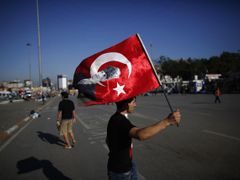 Demonstrant s tureckou vlajkou na istanbulskému náměstí Taksim.