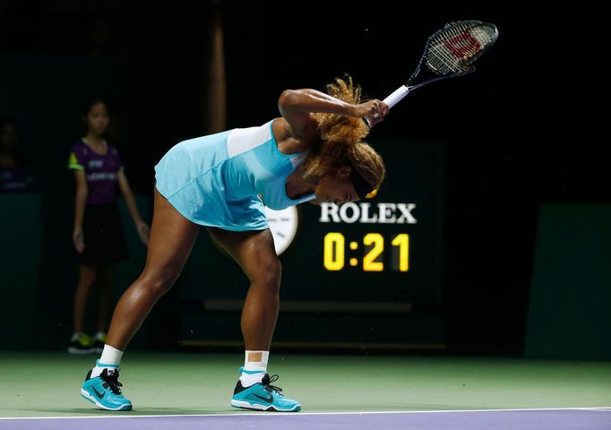 Serena Williams of the U.S. smashes her second racquet during her WTA Finals singles semi-finals tennis match against Caroline Wozniacki of Denmark at the Singapore Indoo